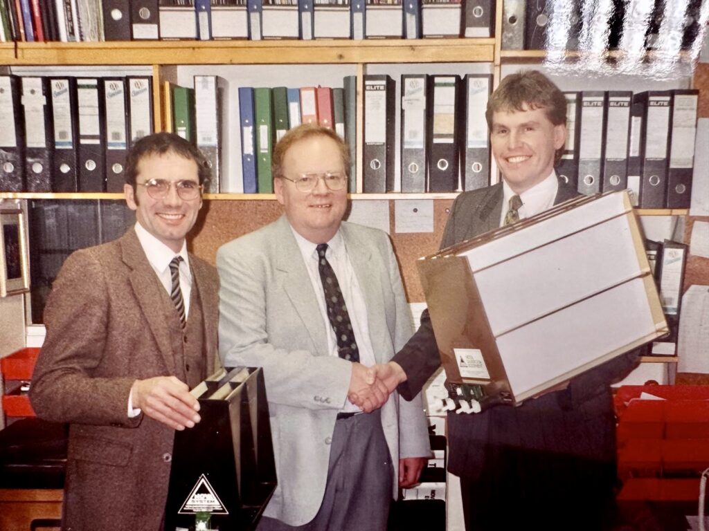 Robin and Graham shaking hands with the gentleman who placed the first order