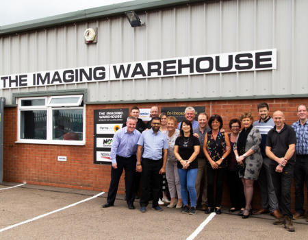 Team picture outside the front entrance of the factory in Stratford